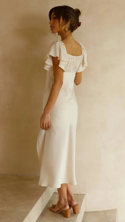 Elegante vestido midi marfil con encantadores hombros al aire